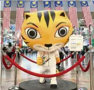  ?? — EBBY SAIFUL/The Star ?? Rimau, the SEA Games mascot at KL Sentral. Will the only tigers we see one day be inside zoo cages?