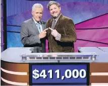  ??  ?? Jeopardy! host Alex Trebek, left, with contestant Austin Rogers, whose 12-game winning streak came to an end on Thursday.