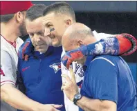  ?? CP PHOTO ?? Toronto Blue Jays’ Troy Tulowitzki, centre, is helped off the field by trainers Mike Frostad, left, and George Poulis after he injured himself awkwardly running across the first base bag in the third inning of their American League MLB game against the...