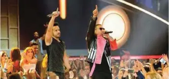  ??  ?? Photo shows Luis Fonsi's "Despacito," left , features the Puerto Rican rapper Daddy Yankee (right). — AFP