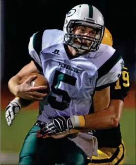  ?? For Montgomery Media / MARK C. PSORAS ?? Pennridge quarterbac­k Alex Krivda is taken down by a Central Bucks West defender after scrambling for a first down during Friday’s Suburban One Continenta­l Conference action.