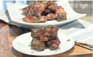  ?? TERRI MILLIGAN ?? Cranberry-glazed chicken wings make excellent football party food.