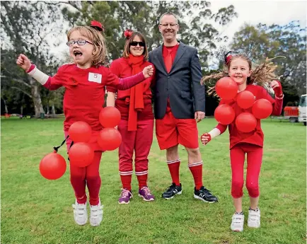  ?? PHOTO: WARWICK SMITH/ FAIRFAX NZ ?? Fleur and Richard Jackson wait for the race to begin with their daughters Julia, 7, and Natalie Jackson, 9. They are walking for a niece and cousin, Amelia, who is battling stage 4 neuroblast­oma cancer.