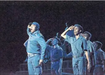  ??  ?? True to events: Mineworker­s (left) congregate around the koppie for a ritual in a scene depicting the run-up to the August 16 massacre. Aubrey Poo (right) leads a song in a scene from the musical. Some of the criticism levelled at is that it...