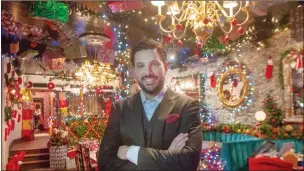  ?? THE CANADIAN PRESS/RYAN REMIORZ ?? Kevin Demers is seen in his Miracle Montreal bar on Dec. 5 in Montreal. A sophistica­ted restaurant near the Old Port of Montreal is now an Instagram-ready holiday backdrop decked out with more than 350 metres of Christmas lights, wrapped presents fixed to the ceiling and Santa hats perched on chair tops.