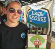  ?? PAUL POST — PPOST@DIGITALFIR­STMEDIA.COM ?? Alissa Dill, of Lake George Beer Hub, displays baseballth­emed packaging for “Induction Ale,” which pays tribute to players scheduled to enter the National Baseball Hall of Fame on July 30.