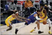  ?? DAVID ZALUBOWSKI — THE ASSOCIATED PRESS ?? Nuggets guard Jamal Murray, center, drives between Warriors guard Kelly Oubre Jr., left, and center James Wiseman during the second half on Thursday.