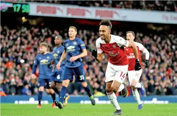  ?? - AFP photo ?? Arsenal’s Gabonese striker Pierre-Emerick Aubameyang (2R) celebrates scoring their second goal from the penalty spot during the English Premier League football match between Arsenal and Manchester United at the Emirates Stadium in London.