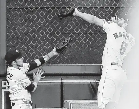  ?? Brett Coomer / Houston Chronicle ?? Astros center fielder Jake Marisnick (6) beats left fielder Josh Reddick to a deep fly ball by Blue Jays first baseman Justin Smoak, snagging it for the third out in the sixth inning Tuesday night.