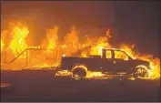  ?? Peter Dasilva EPA/Shuttersto­ck ?? FLAMES from the Camp fire engulf Paradise, Calif. Some residents had to wait it out in a parking lot.