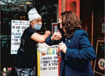  ?? KAMIL KRZACZYNSK­I/GETTY-AFP ?? Vice President Kamala Harris, right, is greeted outside of Brown Sugar Bakery in Chicago on Tuesday.