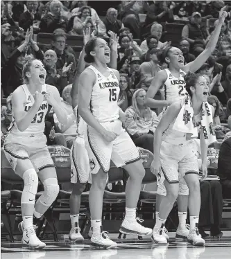  ?? JESSICA HILL/AP PHOTO ?? UConn stars Katie Lou Samuelson (33), Gabby Williams (15), Kia Nurse (11) and Azurá Stevens (23) enjoyed the view from the bench in the fourth quarter as the Huskies set NCAA tournament records for points in a quarter (55), a half (94) and a game (140)...