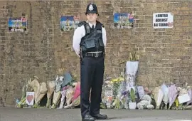  ?? Isabel Infantes AFP/Getty Images ?? FLOWERS line a sidewalk in Finsbury Park, where authoritie­s say a 47-year-old man from Wales ran down Muslims leaving a pair of mosques in north London.