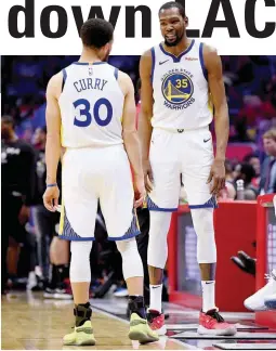  ?? (AFP) ?? Kevin Durant and Steph Curry join hands for 59 points in Golden State’s 132-105 win over the Los Angeles Clippers in Game 3 on Thursday.