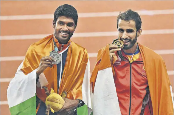  ?? AFP ?? India's Manjit Singh (right) and Jinson Johnson celebrate their 12 finish in men’s 800m event at the Asian Games on Tuesday.