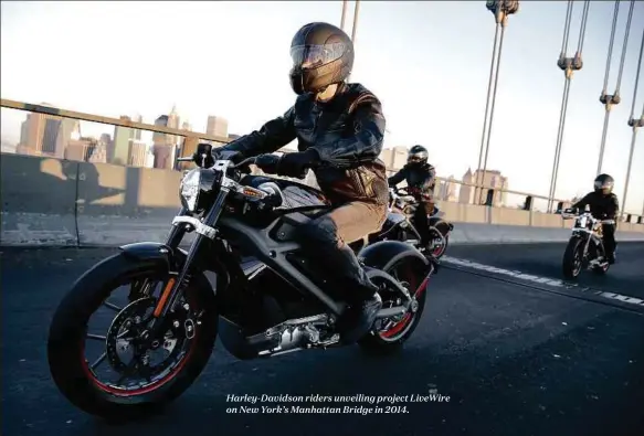  ??  ?? Harley-Davidson riders unveiling project LiveWire on New York’s Manhattan Bridge in 2014.