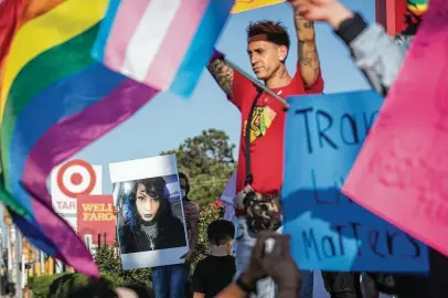  ?? Brett Coomer / Staff photograph­er ?? Friends and family of Iris Santos, a transgende­r woman shot to death outside a Chick-fil-A, hold a vigil for her Wednesday.