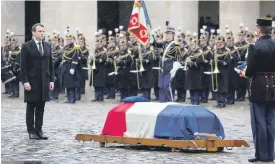  ?? AFP ?? President Emmanuel Macron at the coffin of Lt-Col Arnaud Beltrame in March. Beltrame was killed after offering himself as a hostage in an attack in Trebes