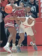  ?? JIM THOMPSON/ALBUQUERQU­E JOURNAL FILE PHOTO VIA AP ?? New Mexico’s JJ Caldwell, right, knocks the ball loose against New Mexico State on Dec. 14. Caldwell, who was suspended from the team Dec. 22, is transferri­ng.