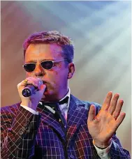  ?? ?? ■ Welcome to the house of fun: Suggs of Madness entertains the rude boys and girls at the Telewest Arena in Newcastle, 11 December 2002