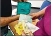  ?? STAFF FILE ?? A family examines a Narcan kit for opioid overdose at a Conversati­on for Change program in Springfiel­d.