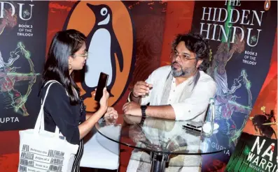  ?? (SPECIAL ARRANGEMEN­T) ?? Author Akshat Gupta (right) interacts with an influencer at Penguin Palooza last month.