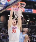  ?? JULIE JACOBSON/AP ?? Virginia center Jack Salt (33) dunks against North Carolina. Virginia (31-2) is the overall No. 1 seed in the tournament that was unveiled on Sunday.