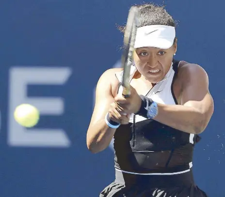  ?? AP ?? Naomi Osaka of Japan returns a shot to Magda Linette of Poland during the second round of the US Open tennis championsh­ips in New York.