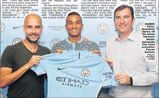  ??  ?? HANDS FULL: Guardiola shows off his latest full-back Danilo alongside City chief executive Ferran Soriano