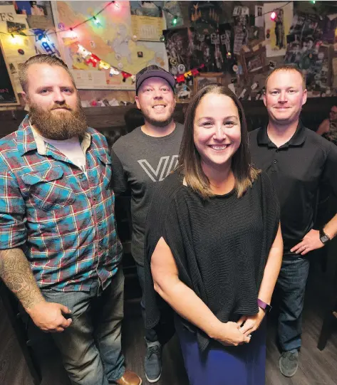  ?? MICHAEL BELL ?? Regina residents Mark Barnard, left, Andy Hilderman, and Mike Landry saved Julie Slade’s life 10 years ago when she was trapped in a burning car. They remain close and met at Leopold’s Tavern East this week when Slade was passing through the city.