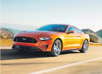  ??  ?? The Mustang GT Coupe is available with a six-speed manual gearbox and a dazzling colour known as Orange Fury.