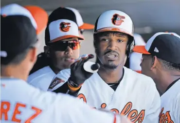  ?? KIM KLEMENT, USA TODAY SPORTS ?? Adam Jones, center, says he has been subject to racist tauntsmany times throughout his career.