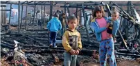  ?? AFP ?? Syrian refugees check the damage following the fire that ripped through their refugee camp in Yammouneh. —