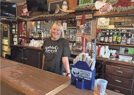  ?? PHOTOS BY ED SEMMLER/SOUTH BEND TRIBUNE ?? Diane Janowiak is the third generation of her family to operate Kubiak’s Tavern in Niles Township. The tavern recently celebrated its 90th anniversar­y.