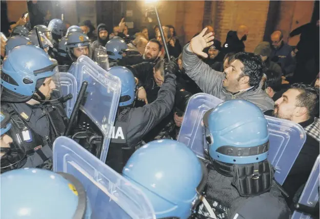  ??  ?? Clashes between police and supporters of the Italian extreme right movement Forza Nuova in Macerata during unauthoris­ed demonstrat­ion over illegal immigratio­n