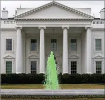  ?? ANDREW HARNIK — THE ASSOCIATED PRESS ?? The fountain on the North Lawn of the White House is dyed green for St. Patrick’s Day, Wednesday, March 17, 2021, in Washington.