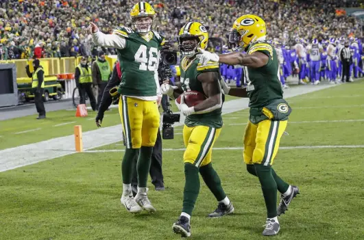  ?? Kamil Krzaczynsk­i, The Associated Press ?? Packers inside linebacker Krys Barnes, middle, is encouraged to celebrate with fans after a defensive stop and fumble recovery against the Los Angeles Rams during the second half Sunday in Green Bay, Wis.