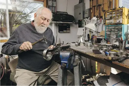  ?? JANA CHYTILOVA ?? Colin Hamer planishes the bottom part of a pewter jug in his workshop.