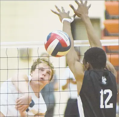  ?? John Nash/For Hearst Connecticu­t Media ?? Staples’ David Kalinowski, left, sends down a kill past the block attempt of East Hartford’s Victor Murphy during Monday’s CIAC Class L boys volleyball semifinal at Shelton High School.