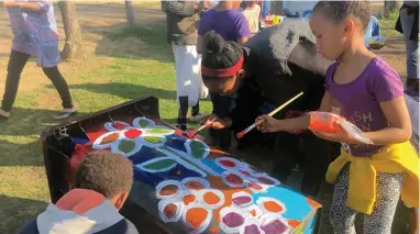  ??  ?? CREATIVE OUTLET: Solo Studios assisted in an event where 30 children decorated black wheelie bins with paint.