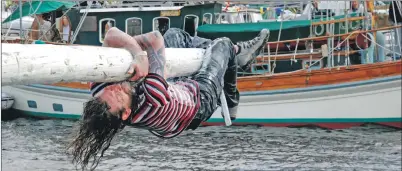  ??  ?? The greasy pole offers a real challenge to hardy competitor­s. a30Tarboat­s02