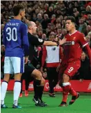  ??  ?? Everton’s Mason Holgate (L) squares up to Liverpool’s Roberto Firmino