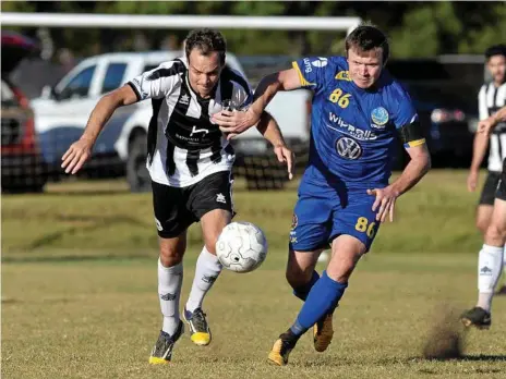  ?? Photo: Kevin Farmer ?? CLOSE BATTLE: Willowburn’s Peter Millican (left) competes for the ball with USQ FC’s Brendan Willmot. Willowburn was the only team to beat minor premiers USQ this season.