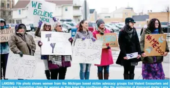  ??  ?? LANSING: File photo shows women from the Michigan based victim advocacy groups End Violent Encounters and Firecracke­r Foundation cheer for women as they leave the courthouse after the sentencing of disgraced doctor Larry Nassar in Ingham County Circuit...