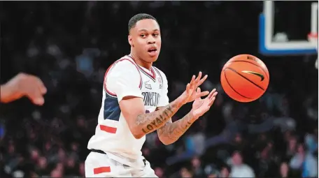  ?? AP PHOTO/FRANK FRANKLIN II ?? UConn’s Jordan Hawkins makes a no-look pass during the Huskie’s game against Providence in the Big East tournament quarterfin­als last week at Madison Square Garden in New York.