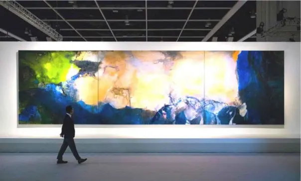  ??  ?? In this photo taken on September 26, a man walks past ‘Juin-Octobre 1985’ by Chinese painter Zao Wou-Ki during a media preview for the piece at the Sotheby’s auction house showroom in Hong Kong ahead of its auction on September 30. A ten-metre-long triptych by Zao Wou-Ki -- known by now as one of the most prominent Chinese painters of the last century -- fetched US$65 million at auction, Sotheby’s Hong Kong said on September 30. — AFP photo