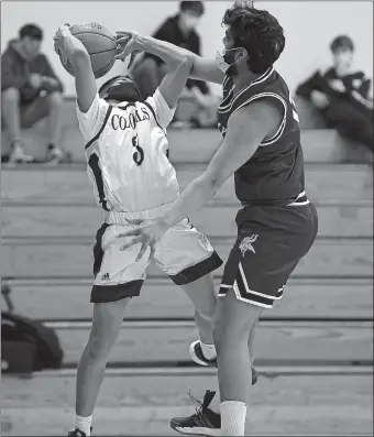  ?? SARAH GORDON/THE DAY ?? Ledyard’s Peyton Luther, left, is defended by East Lyme’s Sujesh Kurumbail during Tuesday night’s ECC boys’ basketball game at Ledyard. The Vikings won 56-34.