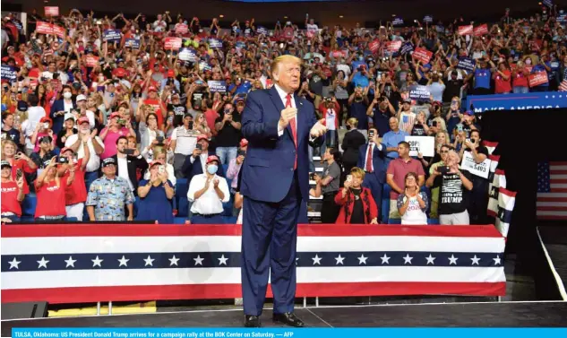  ?? — AFP ?? TULSA, Oklahoma: US President Donald Trump arrives for a campaign rally at the BOK Center on Saturday.