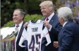  ?? SUSAN WALSH — THE ASSOCIATED PRESS ?? President Donald Trump holds up a jersey presented to him by New England Patriots owner Robert Kraft, right, and head coach Bill Belichick during a ceremony on the South Lawn of the White House in Washington, Wednesday. The president honored the Pats...