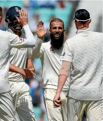  ?? GETTY IMAGES ?? Moeen Ali , centre, removed Dean Elgar, Kasigo Rabada and Morne Morkel in consecutiv­e balls for the first test hat-trick by and English spinner since 1938.